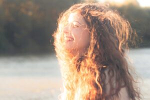 girl smiling with sun streming on her face